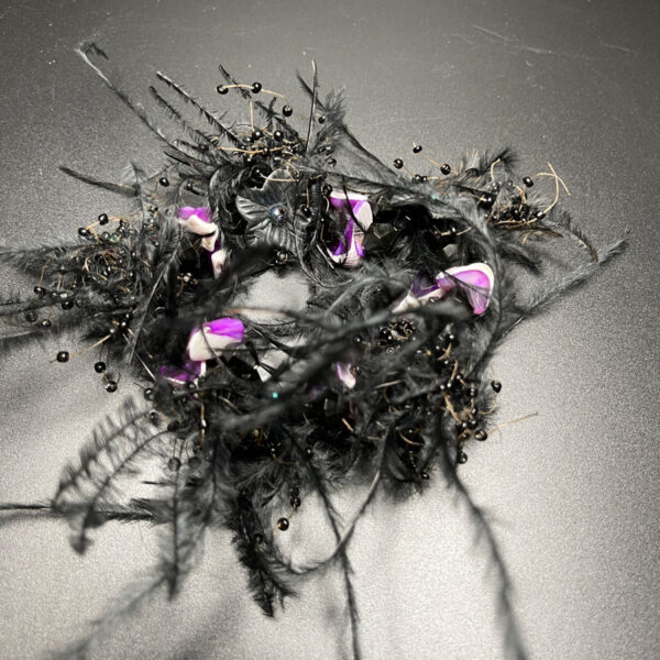 Black feathered head band.