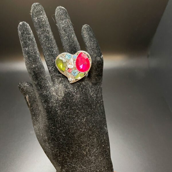 Heart shaped ring on a mannequin hand.