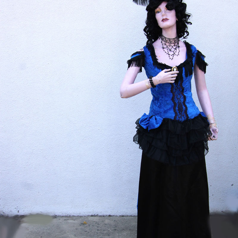 Lady mannequin dress in a vintage blue and black dress with hat.