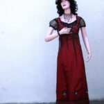 Lady mannequin in a red vintage dress and black wig.