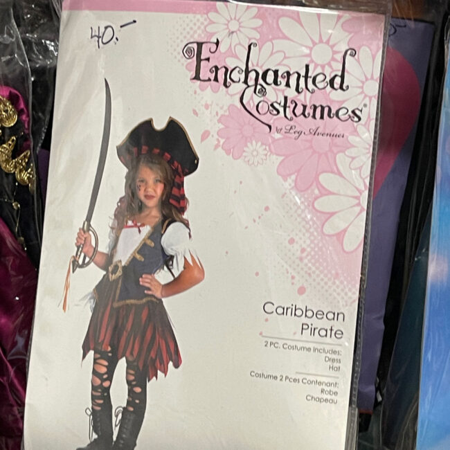 Little girl in a Priate costume on the cover of a plastic package.