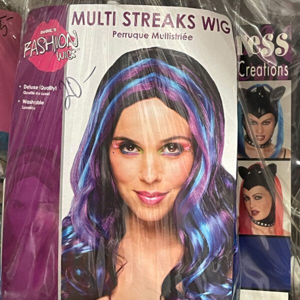 Blue, black, and purple streaked wig in plastic package.