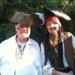 Two men in pirate costumes.