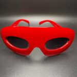 Red glasses with dark lenes.