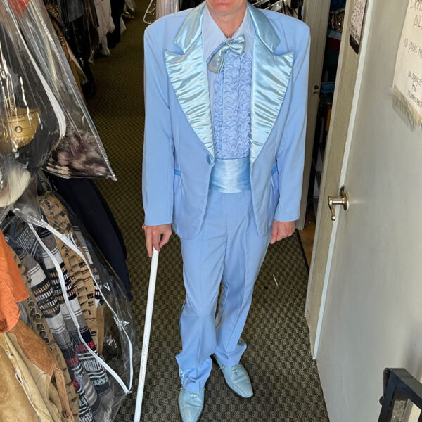 Man in a 20's blue suit with blue top hat.