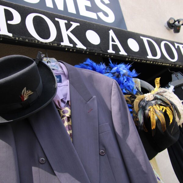 20's suit and dresses hanging from Pok-a-dot's awning outside.